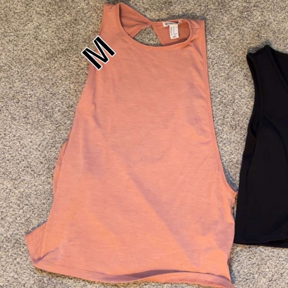 A workout tank top has a open back